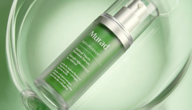 Murad Resurgence Blemish Youth Removal Serum in a clear bottle with a green label and silver pump, resting inside a clear glass bowl on a light green background.