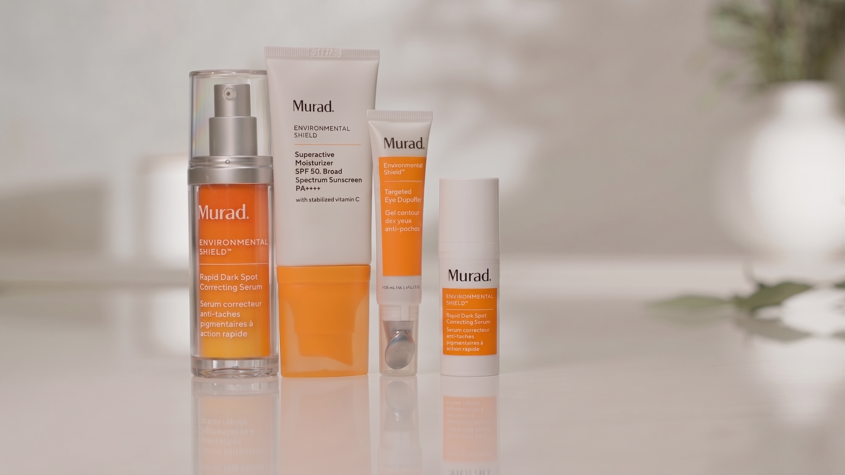 Murad skincare products on a neutral background